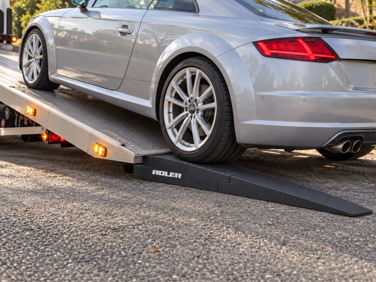 TOR4 two-piece tow ramp helping a silver sports car transition onto a tilted recovery-truck bed.